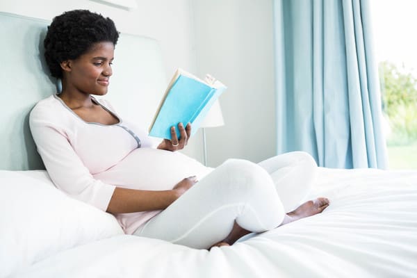 21481560 pregnant woman reading a book